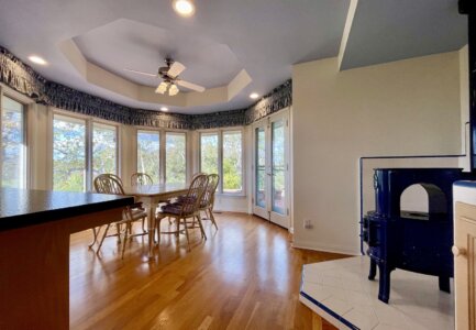 Kitchen and dining area during rainy day Fallbrook open house at 145 Yucca Road with windows looking out to trees.