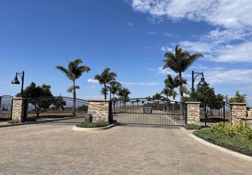 Gated community entrance in Vista California where real estate fraud was discovered after imposters could not provide property access code