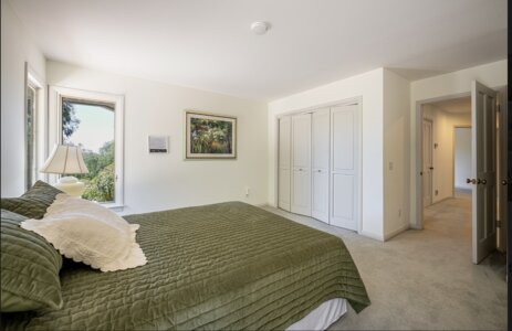 Secondary bedroom with natural light and dresser at Fallbrook Open House estate.
