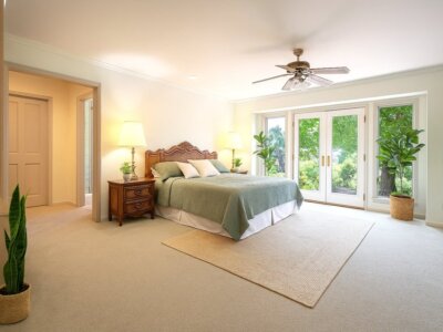 Primary bedroom with French doors opening to greenery at 145 Yucca Rd Fallbrook Open House